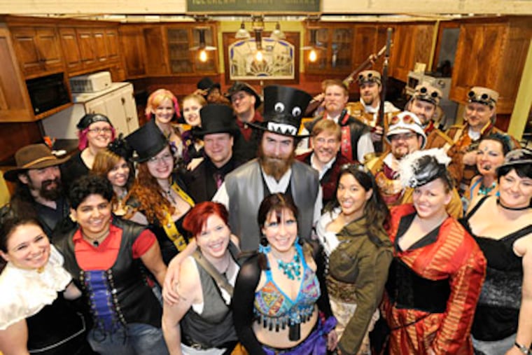 Gil Cnaan (center in top hat), found of Dorian's Parlor, and some Steampunk friends. Their monthly gathering will be Saturday. (CLEM MURRAY / Staff Photographer)