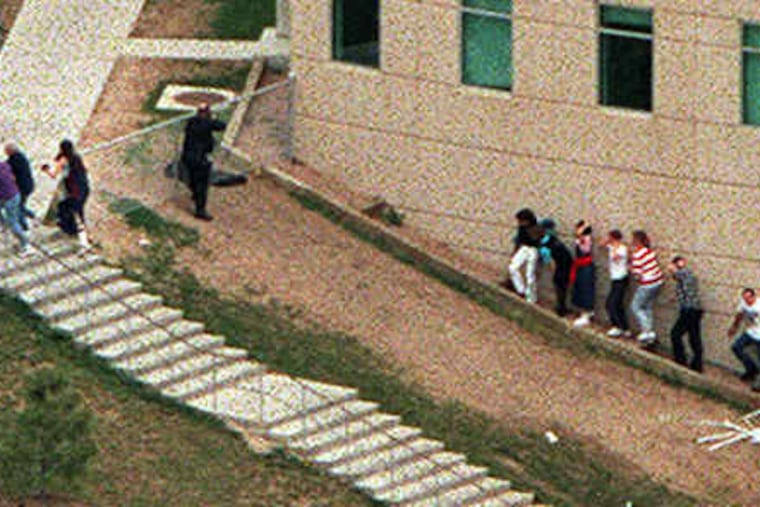 In an April 20, 1999, photo, police officers and students during the Columbine High School massacre in Littleton, Colo. Despite lingering scars, many victims are fine.
