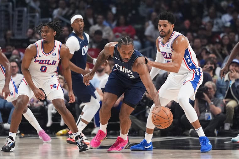 Los Angeles Clippers forward Kawhi Leonard is pressured by the Sixers' Tyrese Maxey (0) and Tobias Harris during the first half Sunday.