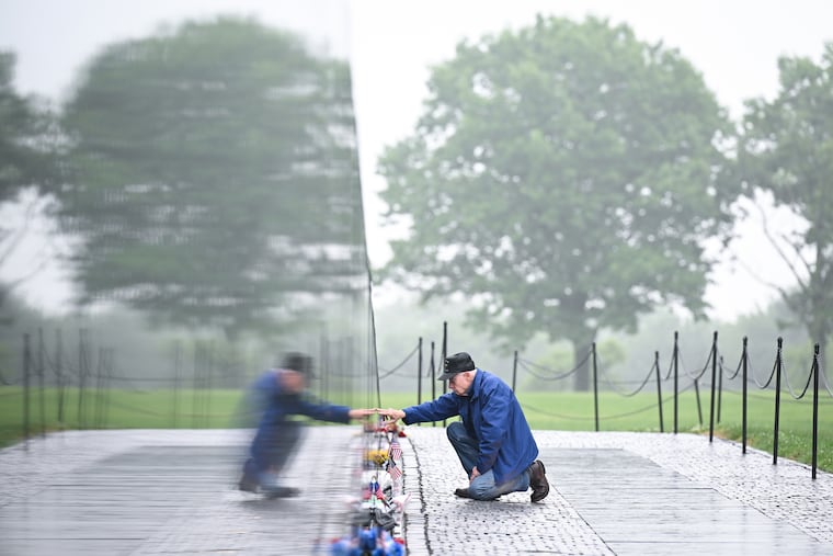 Veteran David Loesch visits the Vietnam Veterans Memorial on Monday.