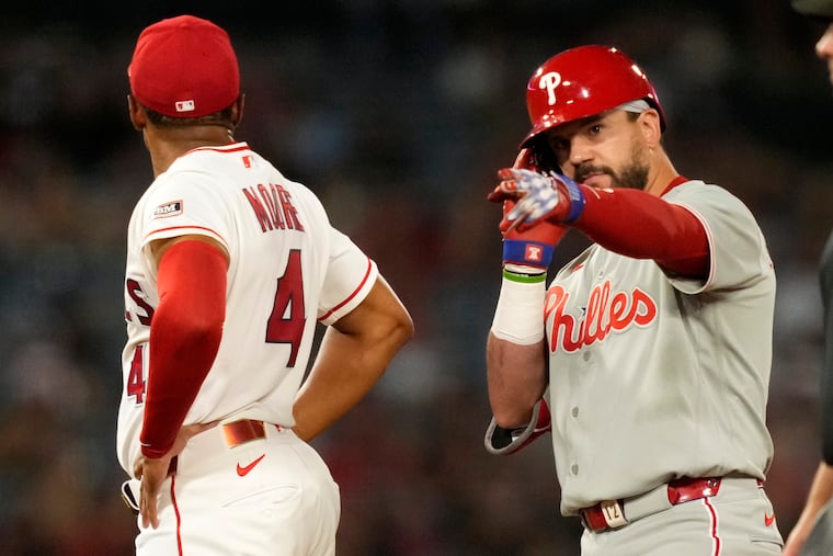 Kyle Schwarber (right) celebrates his 10th inning RBI double.