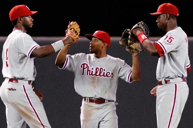 Ben Revere (center) celebrates with left fielder Domonic Brown (left) and right fielder John Mayberry Jr. (15) after defeating the Minnesota Twins 3-2 in a baseball game on Thursday, June 13, 2013, in Minneapolis. (Genevieve Ross/AP)