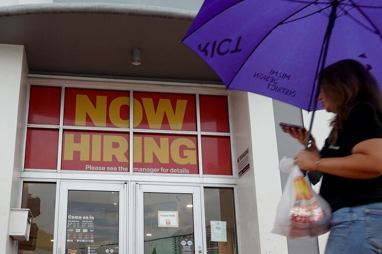 A "Now Hiring" sign hangs above the entrance to a McDonald's restaurant on Nov. 5, 2021, in Miami Beach, Florida. (Joe Raedle/Getty Images/TNS)