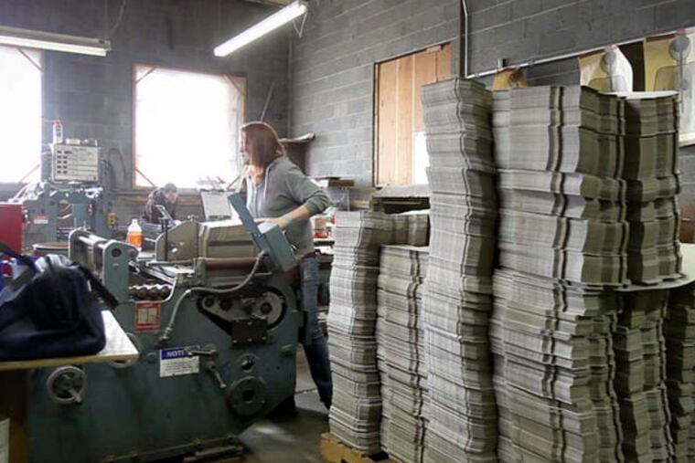 On the factory floor of the Midvale Paper Box Co. in Luzerne County, a worker pushes finished boxes through a sorting machine. Worker training and a willingness to adjust have been key for owner David Frank, who bought the plant in 1999. (Ed Hille / Staff Photographer)