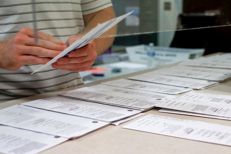 Mail-in ballots for the Pennsylvania primary election are processed at the Butler County Bureau of Elections, in Butler, Pa., on May 28. Pennsylvania officials said July 31 the state will foot the cost of postage for voters to mail in ballots in November's general election, a move that Gov. Tom Wolf has made a priority as the coronavirus pandemic unexpectedly fueled high interest in voting by mail under a new state law.
