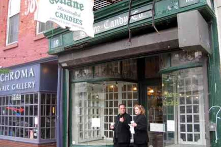 The display windows at Old City's Shane Candy Co. were empty this week, but their barren state is not permanent. Neighbors Ryan and Eric Berley bought the business and plan to reopen it.