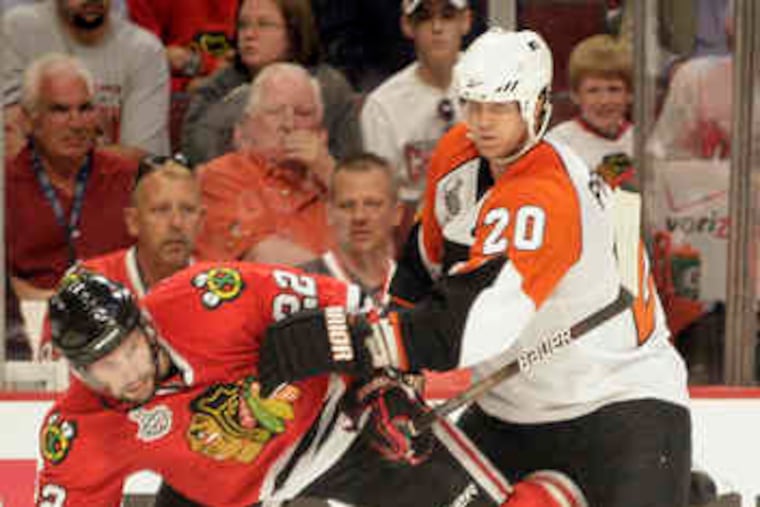 Chicago's Troy Brouwer , tangling with Flyers defenseman Chris Pronger, had two goals andone assist. He was benched for three games in the Vancouver series for lack of productivity.