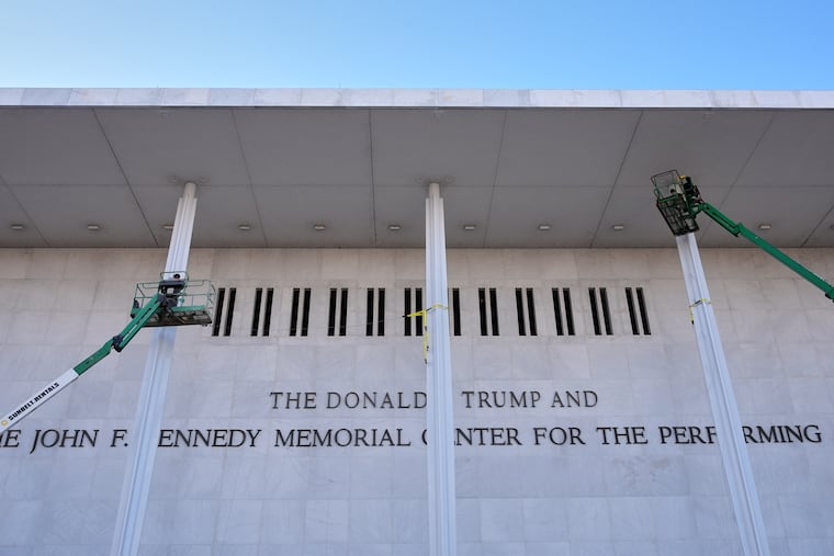 Workers put the finishing touches on new signage at The Donald J. Trump and The John F. Kennedy Memorial Center For The Performing Arts, at the Kennedy Center, in Washington, in December.