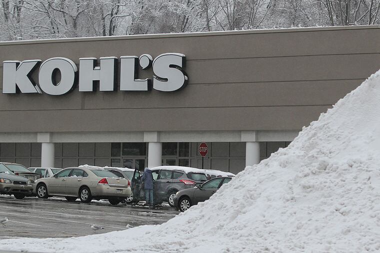 Snow is piled high and parking spots are cleared at the Andorra Shopping Center, but Tuesday's weather kept customers away from Kohl's and other stores. MICHAEL BRYANT / Staff Photographer