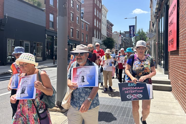 Protesters walk from Christ Church to the ICE field office holding signs to commemorate those who died in ICE detention.