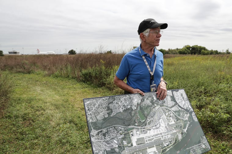 Ray Scheinfeld, who is the Airport Environmental Manager at Philadelphia International Airport, displays a satellite image of the airport on a parcel of recently acquired land in Philadelphia, PA on September 5, 2019.