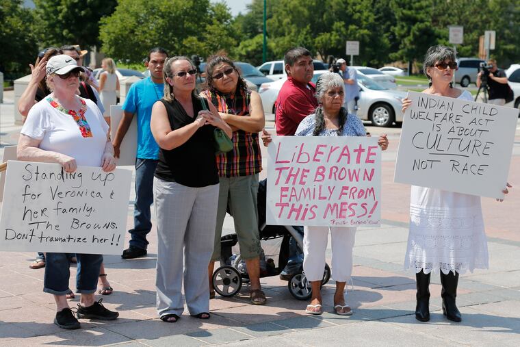 Participants listen during a rally in support of three-year-old baby Veronica, Veronica's biological father, Dusten Brown, and the Indian Child Welfare Act, in Oklahoma City, Monday, Aug. 19, 2013. The U.S. Supreme Court will hear arguments, Wednesday, Nov. 9, 2022 on the most significant challenge to the Indian Child Welfare Act that gives preference to Native American families in foster care and adoption proceedings of Native American children since it passed in 1978.