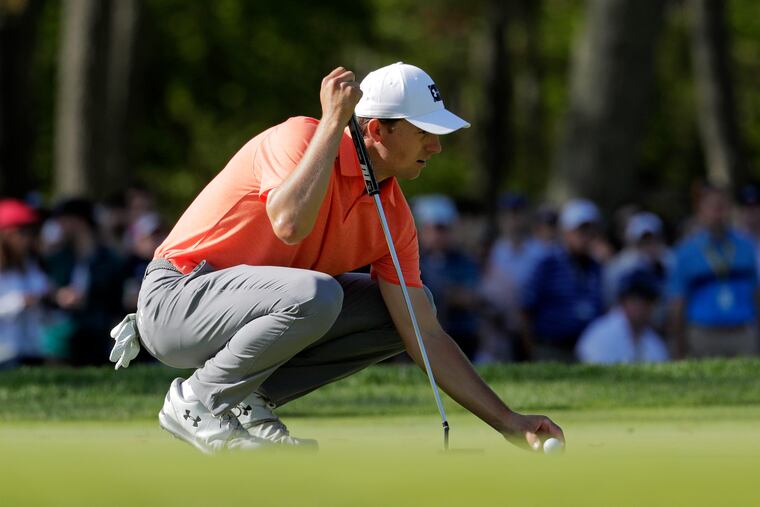 Jordan Spieth lines up a putt on Saturday.