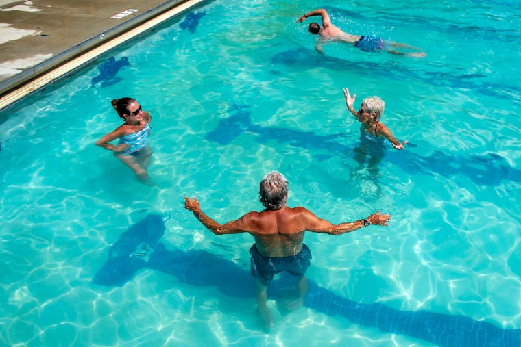 Haddon Township residents enjoy "adult swim" at their town's municipal Crystal Lake Pool June 23, 2020 as New Jersey enters the second week of coronavirus reopenings continue. Clockwise from left are Camie Costanzo, 40; Jeraldine Schachte, 70; Larry Richio, 69. Schachte first came to the pool as a teenager, when it was a lake with a sand bottom. She brought her kids - now in their 40s, when they they young. Under Gov. Murphy's Stage 2 plan private and municipal pools can open for the summer with capacity limited to 50%, swimmers asked to practice social distancing when in the water and no pool toys allowed