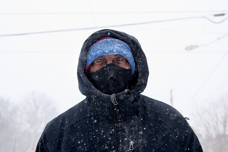 Willie Davis walks down North 41st Street in West Philadelphia after going to the store as snow blows around him on Thursday, Jan. 4, 2018.