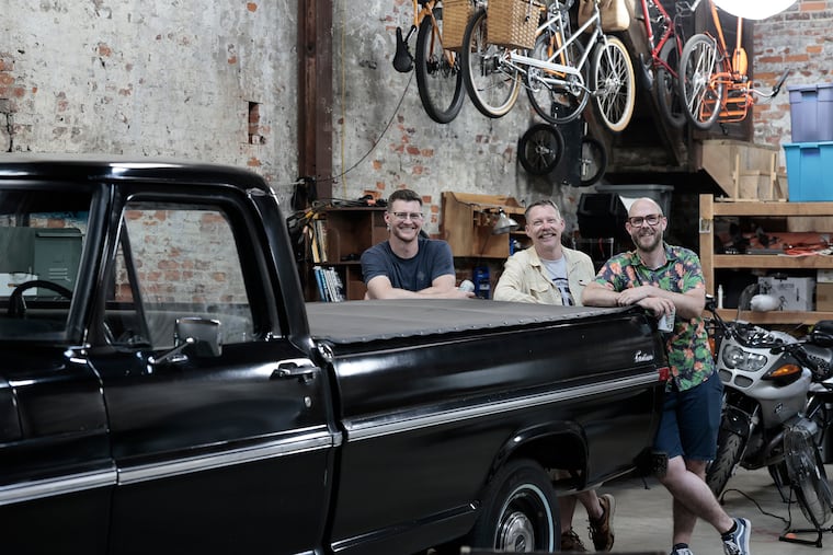 (From left) Jeremy Stock, Luke Elrath, and Corey McMillan in their South Philadelphia garage. The group bought the garage together so they would have a place to work on their cars, trucks, motorcycles, and bikes.