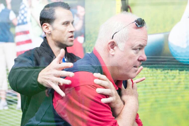 Golf fitness expert Sean Cochran instructs fans on proper golf fitness techniques at the American Express Championship Experience at the 2013 U.S. Open at Merion Golf Club. photography by Terry Ratzlaff / FOR THE DAILY NEWS