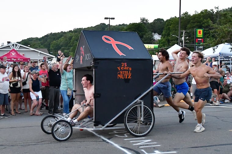Team Nutz celebrates taking first place in the 25th Dushore Founder's Day Outhouse Race on Saturday, Aug. 8, 2026 in Dushore, Pa. The Dushore Lyons Club event featured 10 teams comprised of a driver and four pushers who raced custom-designed outhouses along Main Street as hundreds of locals lined the sidewalks to watch and cheer.