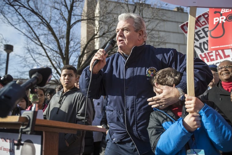 Congressman Bob Brady, head of Philadelphia’s Democratic Party, speaks at a rally and covers the ears of a young person while lambasting Republicans.