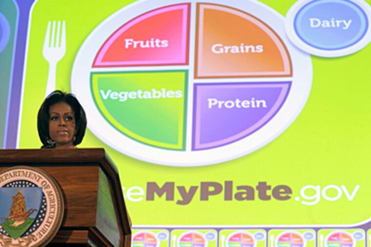 Michelle Obama helps introduce the new food guide. A goal, she said, is making the system simpler for parents. (Susan Walsh / Associated Press)