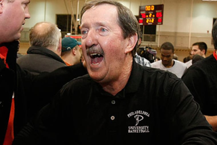 Herb Magee allowed himself to celebrate after setting the all-time NCAA wins record. (Ron Cortes/Staff Photographer)