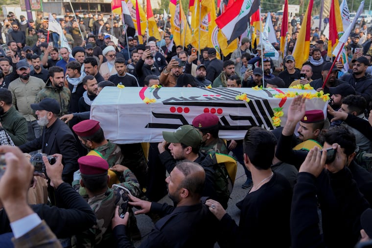 Members of an Iraqi Shiite militant group carry the coffin during the funeral of a fighter with the Kataib Hezbollah, who was killed in a U.S. airstrike, in Baghdad, Iraq, Thursday.