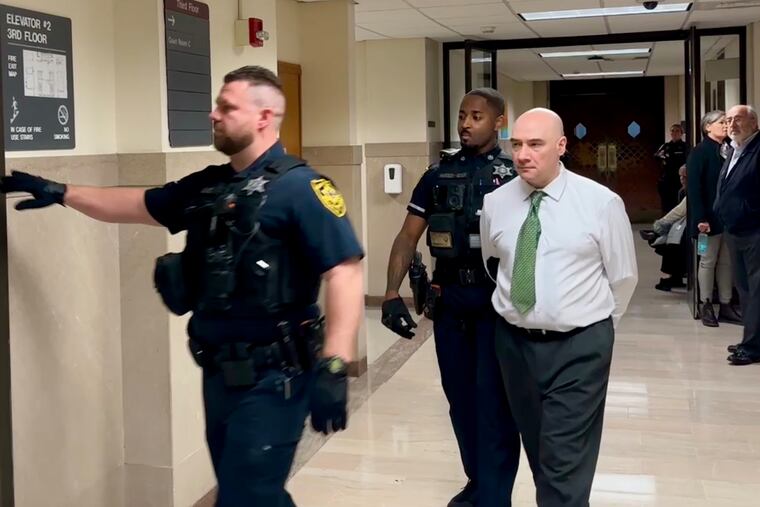 Aaron Deshong is escorted out of a courtroom in the Montgomery County Courthouse on Monday after the start of his trial on first-degree murder and related crimes.