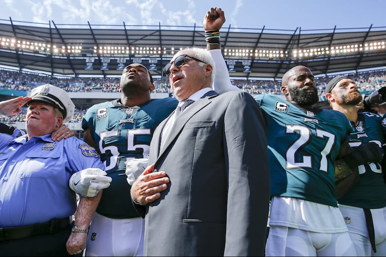 Eagles owner Jeffrey Lurie stands with Eagles defensive end Brandon Graham and strong safety Malcolm Jenkins during the National Anthem before the Eagles play the New York Giants on Sunday, September 24, 2017 in Philadelphia YONG KIM / Staff Photographer