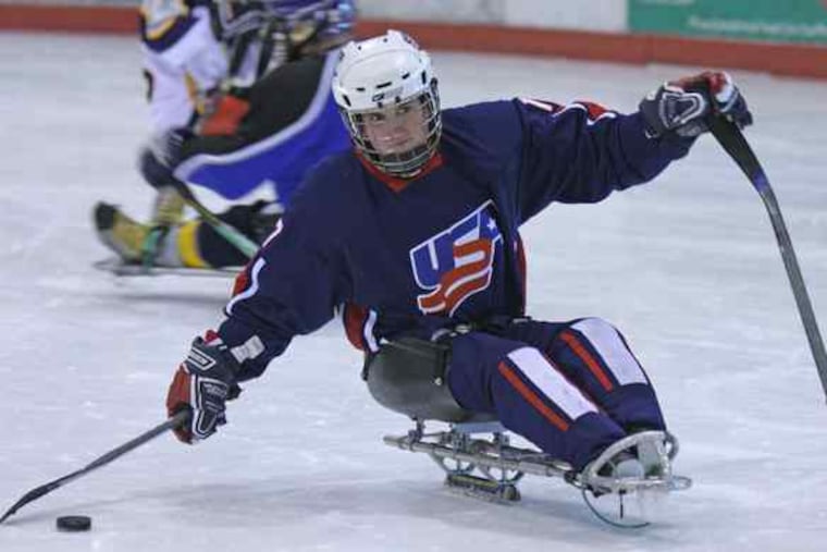 Dan McDevitt gets ready to shoot during a sled hockey practice at IceWorks in Aston. "To represent your country is a great honor," he says of playing on the U.S. junior national team.