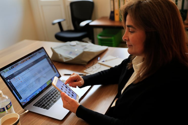 Diana Moukalled, a Lebanese journalist who closely follows social media checks the Clubhouse application, at her office in Beirut, Lebanon, Wednesday, April 7, 2021. Many small businesses are turning to Clubhouse, the fast-growing audio chat app, to build their brands. (AP Photo/Hussein Malla)