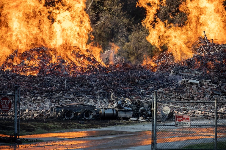 A Jim Beam bourbon warehouse in Woodford County, Ky., burns on Wednesday, July 3, 2019, after catching fire late Tuesday night. (Ryan C. Hermens / Lexington Herald Leader / TNS)