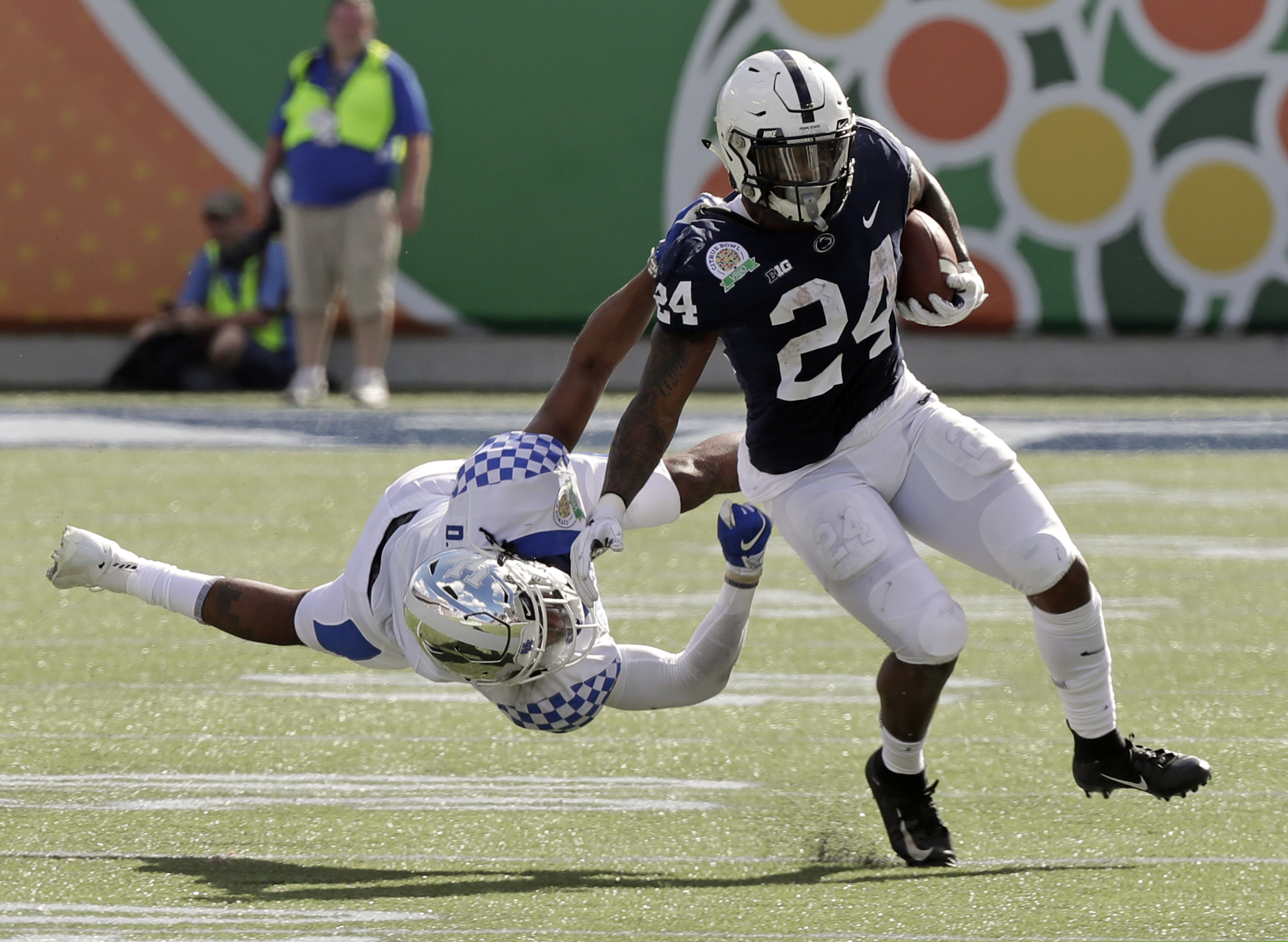 Miles Sanders rushes past Kentucky's Davonte Robinson during Penn State's Citrus Bowl loss on Tuesday.