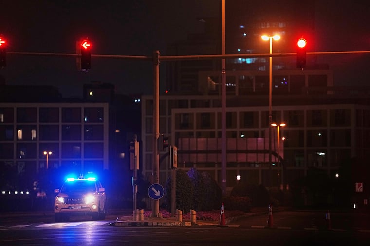 A police car blocks a street leading to the U.S. consulate after an Iranian drone struck a parking lot outside the compound, sparking a small fire in Dubai, United Arab Emirates, early Wednesday, March 4, 2026.