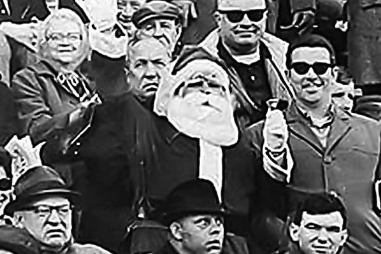 Frank Olivo, center, is shown in this 1967 photograph wearing his Santa suit at an Eagles game. (AP photo)