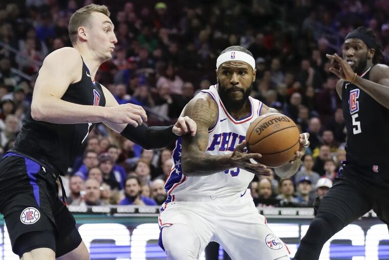 Sixers forward Trevor Booker (center) was waived Wednesday.