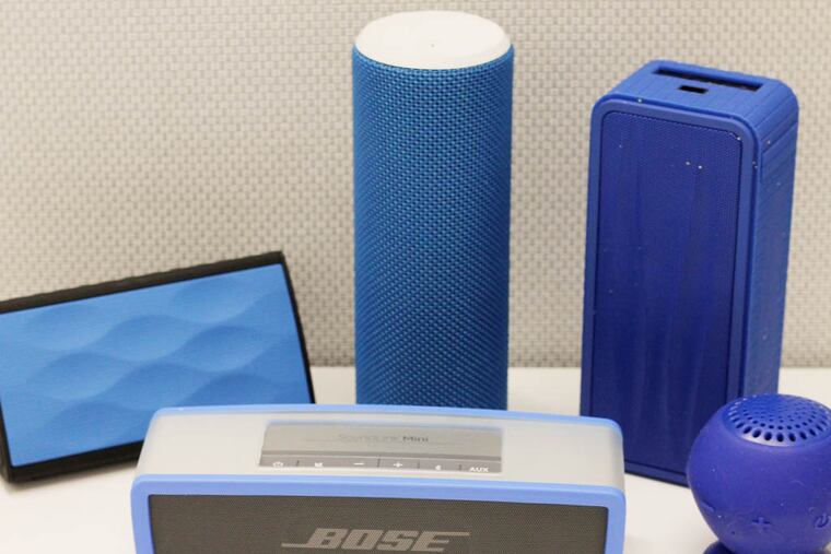 An array of speakers. (Back row left to right) Oontz Angle, Ultimate Ears Boom, Divoo OnBeat-200. (Front row left to right) Bose SoundLink Mini Speaker, AudioSource Sound pOp Bluetooth Speaker. (Courtney Marabella / Staff Photographer )