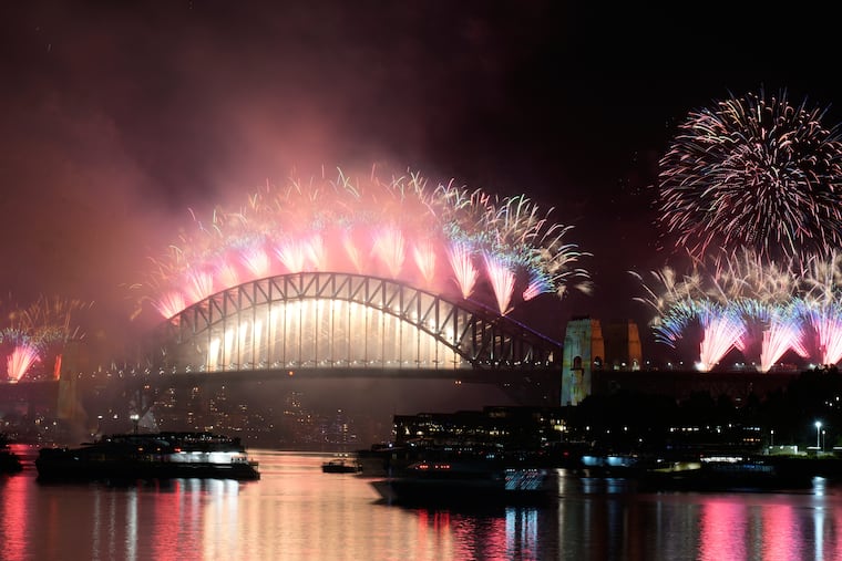 Fireworks burst over the Sydney Harbour Bridge as New Year's celebrations begin in Sydney.