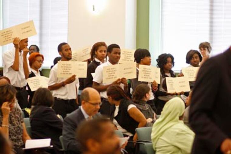 During a Philadelphia School Reform Commission meeting, students stand with signs indicating their college choices. (Michael S. Wirtz / Staff Photographer)