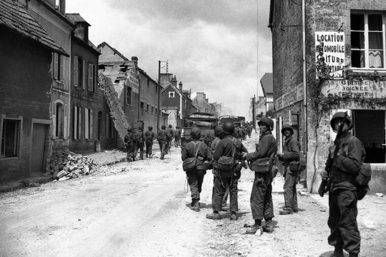 American paratroops patrol in the streets of Sainte-Mere-Eglise, France, on June 11, 1944. About 15,000 paratroopers landed in and around the village not long after midnight on June 6, 1944.