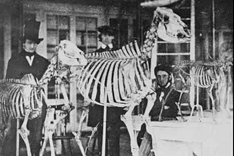 At least two experts believe Edgar Allan Poe is sitting on the right in an 1840s photo taken inside the Academy of Natural Sciences, then on Broad Street. The identities of all three men are in dispute.