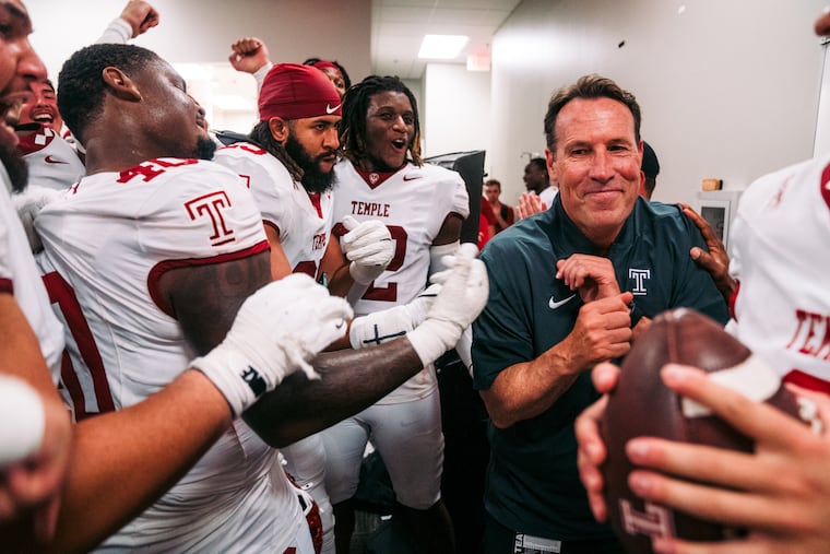 Temple coach K.C. Keeler celebrates with his team after a win.