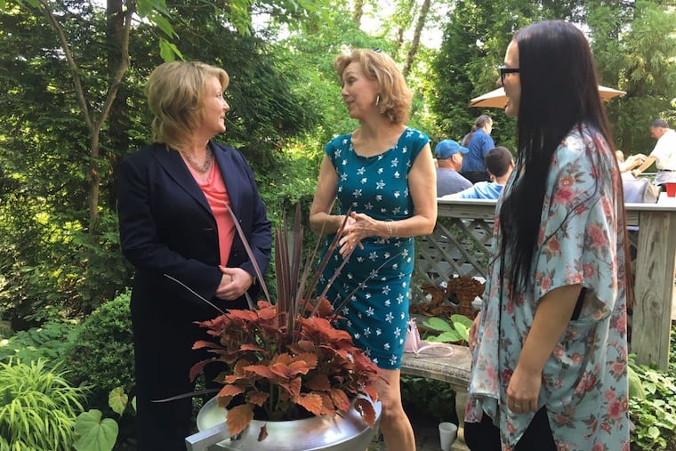 Heather Pool (left), Liz Gibbs, and Kristin Pool (right), friends of the late landscape designer Alan Koch, in the garden at his home to celebrate his life.