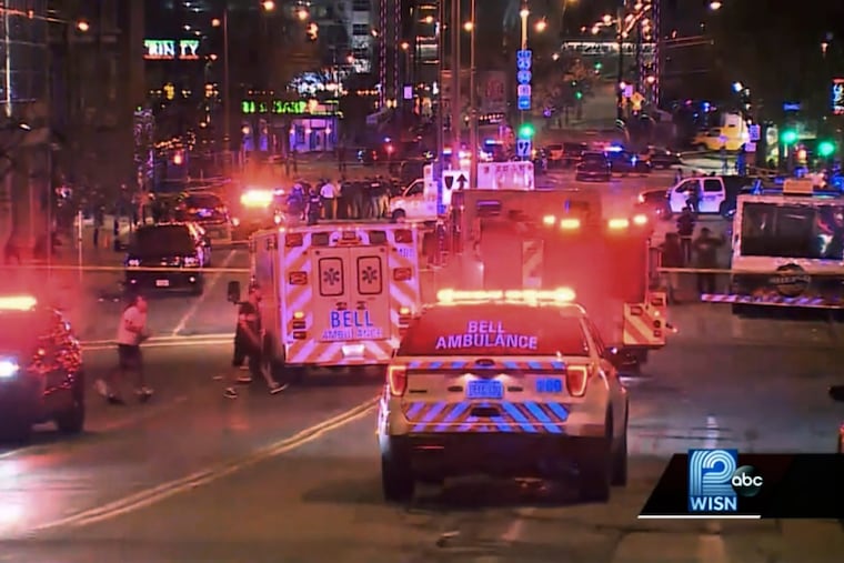 This photo taken from video provided by WISN 12 News shows police responding to the scene of a shooting at Water Street and Juneau Avenue in Milwaukee, Friday, May 13, 2022. Twenty people were injured in two shootings in downtown Milwaukee near an entertainment district where thousands of people were watching the Bucks play the Celtics in the NBA's Eastern Conference semifinals, authorities said. There was no immediate indication whether the two shootings were related or involved fans who were watching the game.