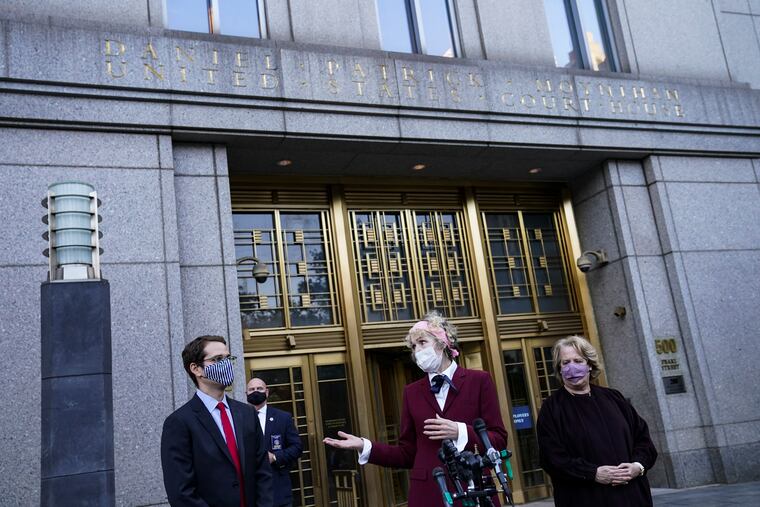 E. Jean Carroll, center, who says President Donald Trump raped her in the 1990s, spoke to reporters as she left the Daniel Patrick Moynihan United States Courthouse following a hearing in her defamation lawsuit against Trump, last Wednesday in New York.