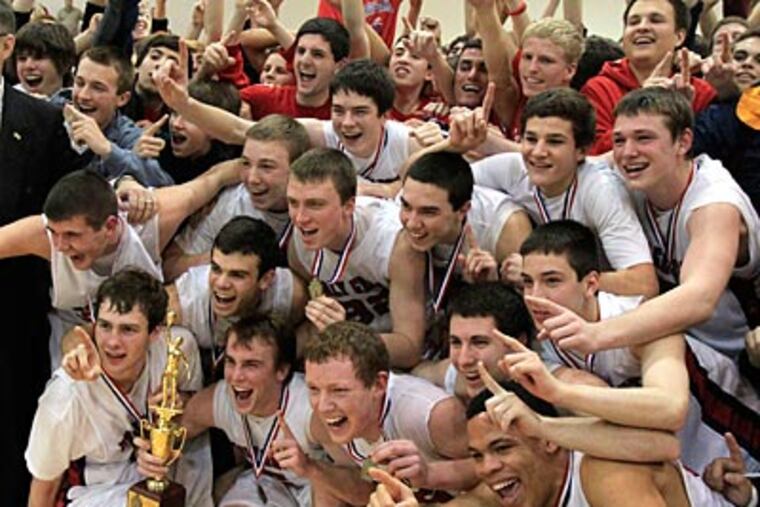 The Holy Ghost players pose with their championship trophy on Saturday night. (Ron Cortes/Staff Photographer)