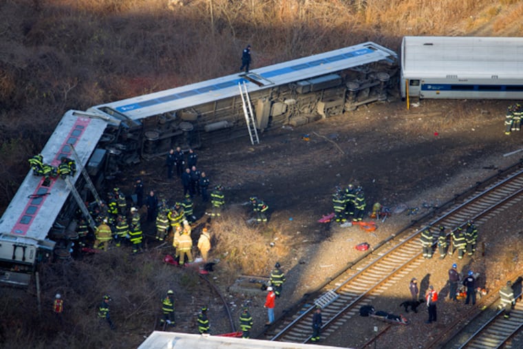 First responders gather at the derailment of a Metro North passenger train in the Bronx borough of New York Dec. 1, 2013 The Fire Department of New York says there are "multiple injuries" in the train derailment, and 130 firefighters are on the scene. Metropolitan Transportation Authority police say the train derailed near the Spuyten Duyvil station. (AP Photo/Craig Ruttle)