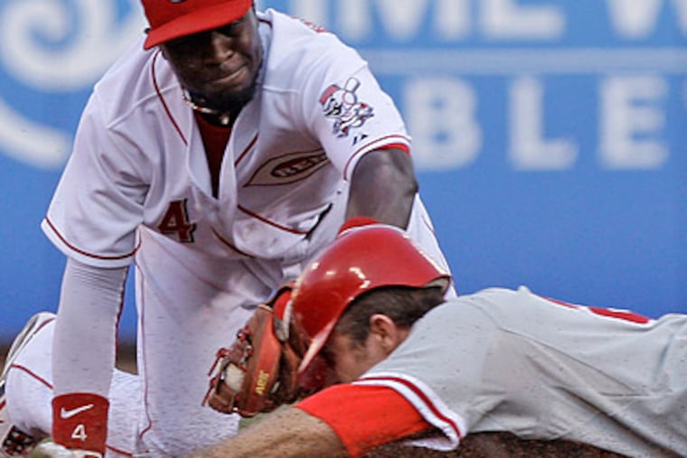 Chase Utley injured his hand on this slide into second base during the fourth inning. (Al Behrman/AP)