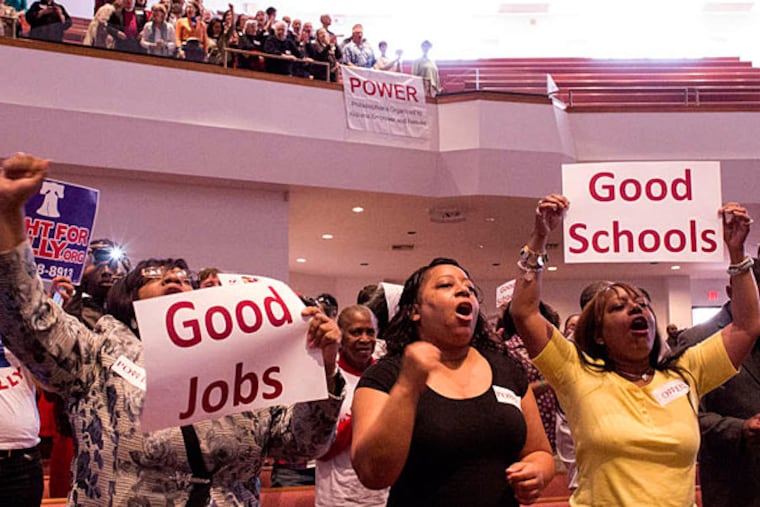 Crowds cheer Sunday at Deliverance Evangelistic Church in North Philadelphia, where Philadelphians Organized to Witness, Empower and Rebuild (POWER) rallied for better wages for airport workers. (Courtney Marabella/Staff)
