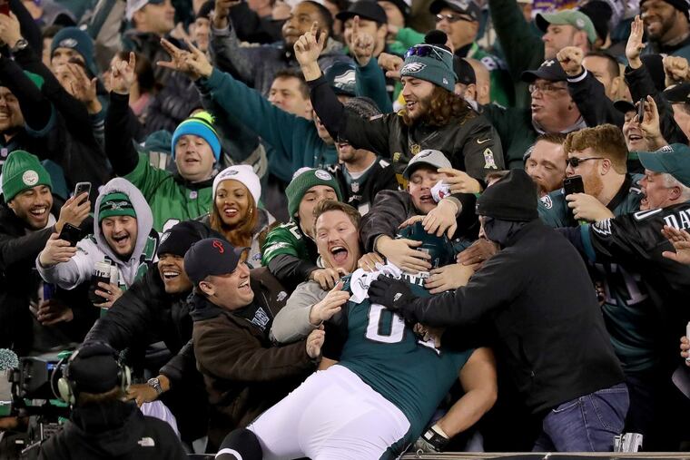 Eagles’ fans celebrate as Stefen Wisniewski, jumps into the stands after Alshon Jeffery scores in the 4th quarter against the Vikings. Philadelphia Eagles win 38-7 over the Minnesota Vikings in the NFC Championship game in Philadelphia, PA on January 21, 2018. They will face the Patriots in the Super Bowl. DAVID MAIALETTI / Staff Photographer