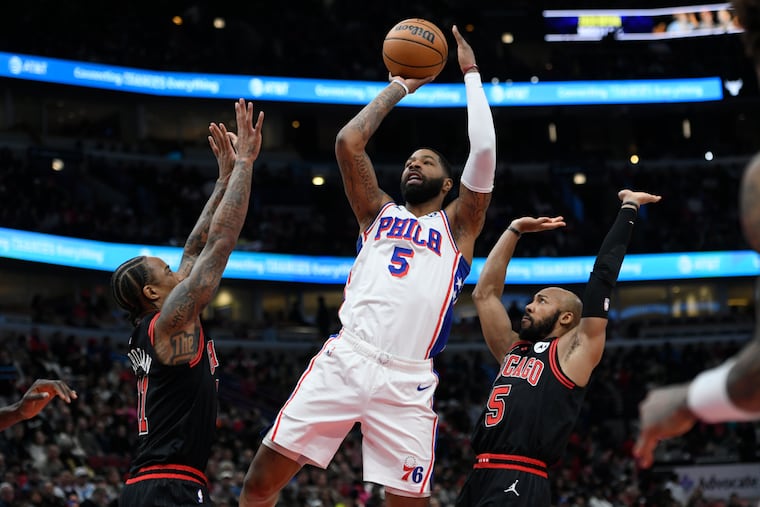 Sixers' Marcus Morris Sr. goes up to shoot against Chicago Bulls' DeMar DeRozan and Jevon Carter during the first half on Dec. 30.